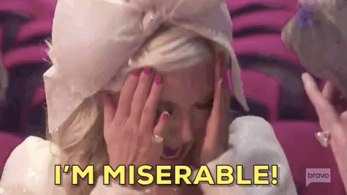 A Woman Is Covering Her Face With Her Hands And Saying I 'M Miserable ! GIF
