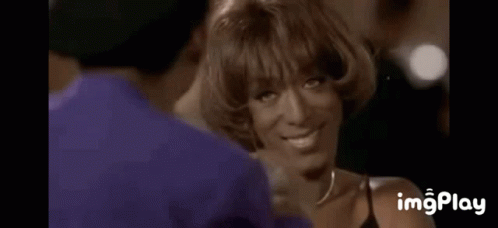 A Woman Is Covering Her Face With Her Hands While A Man Holds Her Hand . GIF