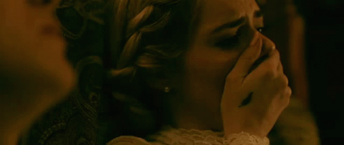 A Woman Is Covering Her Mouth With Her Hand While Another Woman Looks On . GIF