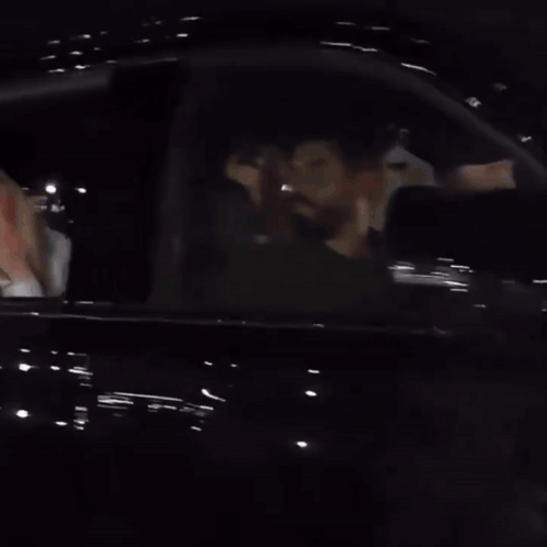 A Woman Is Covering Her Mouth With Her Hand While Sitting In A Car GIF