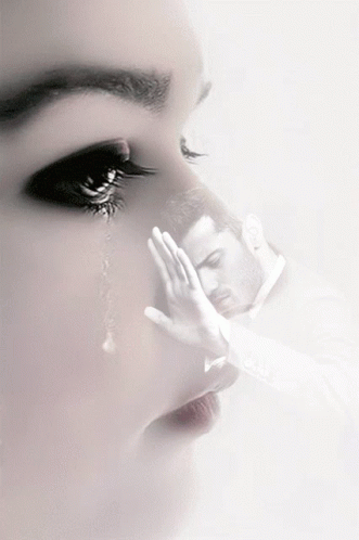 A Woman Is Crying And A Man Is Covering His Face GIF