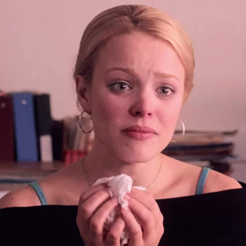 A Woman Is Crying And Holding A Napkin In Her Hand GIF