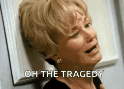 A Woman Is Crying And Leaning Against A Wall With The Words `` Oh The Tragedy '' Written On Her Face . GIF