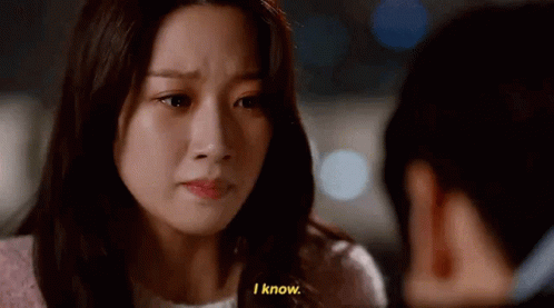 A Woman Is Crying And Talking To Another Woman While A Man Looks On . GIF