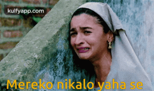 A Woman Is Crying In Front Of A Wall With The Words Mereko Nikalo Yaha Se GIF