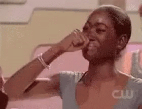 A Woman Is Crying While Covering Her Nose With Her Hand . GIF