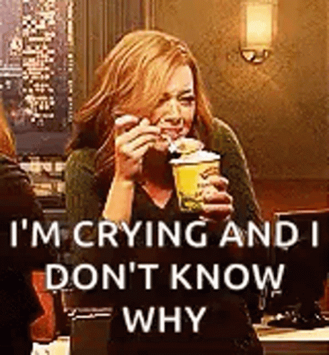 A Woman Is Crying While Holding A Cup Of Coffee And A Sandwich . GIF