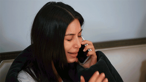 a woman is crying while talking on a cellphone