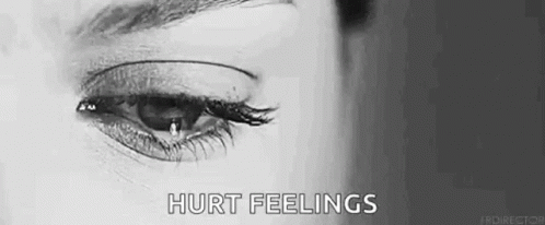 A Woman Is Crying With A Tear Coming Out Of Her Eye In A Black And White Photo . GIF