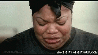 A Woman Is Crying With Her Eyes Closed And Her Headband On . GIF