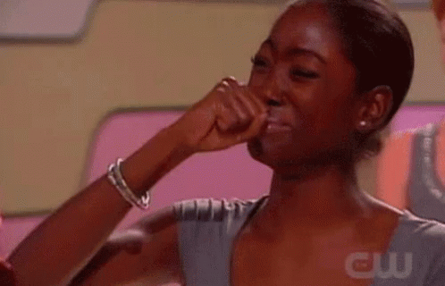 A Woman Is Crying With Her Fist In The Air . GIF