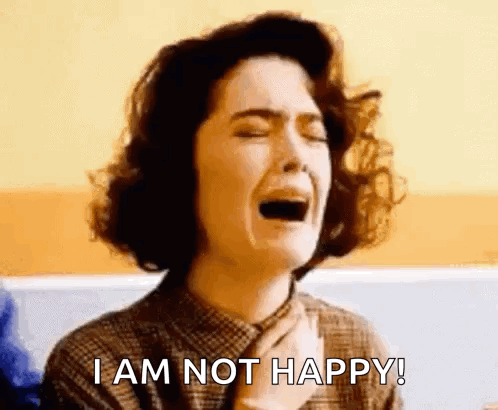 A Woman Is Crying With The Words `` I Am Not Happy '' Written Below Her . GIF