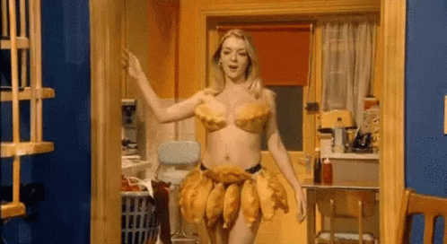 A Woman Is Dancing In A Kitchen Wearing A Dress Made Of Potatoes . GIF