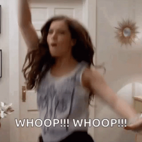 A Woman Is Dancing In A Room With Her Arms In The Air And Says Whoop ! Whoop ! Whoop ! GIF