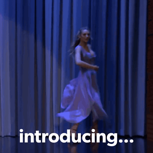 A Woman Is Dancing In Front Of A Blue Curtain With The Words Introducing GIF