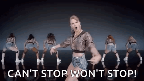 A Woman Is Dancing In Front Of A Group Of Dancers . GIF