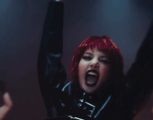 A Woman Is Dancing In Front Of A Screen That Says Futw GIF