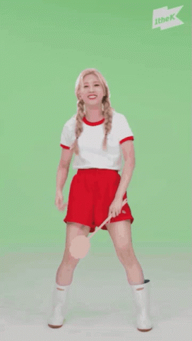 A Woman Is Dancing In Front Of A Sign That Says ' Ithek ' On It GIF