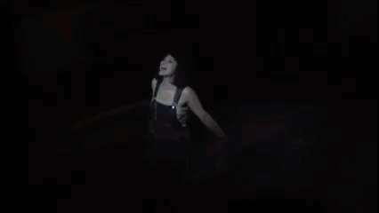 A Woman Is Dancing On A Stage With A Sword In Her Hand GIF