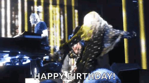 A Woman Is Dancing On A Stage With The Words Happy Birthday Written Below Her GIF