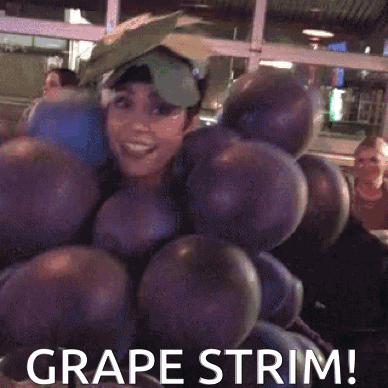 A Woman Is Dressed As A Bunch Of Grapes And Says Grape Trim GIF