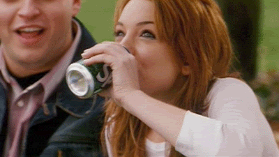 A Woman Is Drinking A Can Of Soda From A Can . GIF