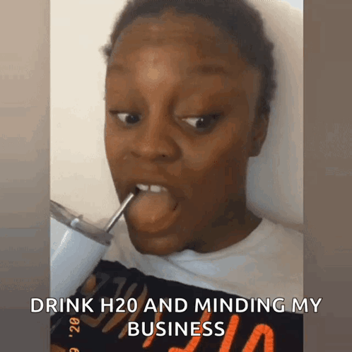 A Woman Is Drinking H2o Through A Straw And Minding Her Business GIF