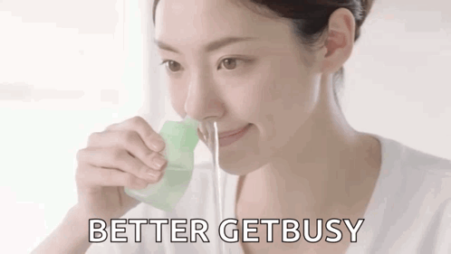 A Woman Is Drinking Water Through A Straw With The Words `` Better Get Busy '' Written Below Her . GIF