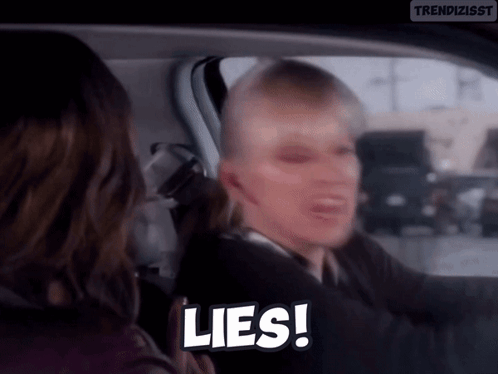 A Woman Is Driving A Car And Talking To Another Woman . GIF