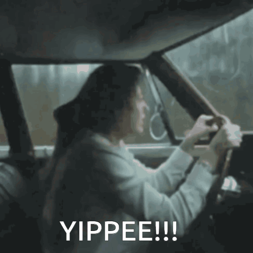 A Woman Is Driving A Car With The Words Yippee Written On The Bottom GIF