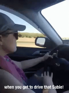 A Woman Is Driving A Subaru With The Caption When You Get To Drive That Subie ! GIF