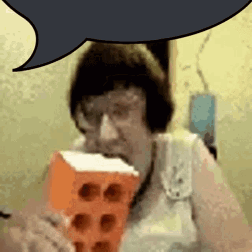 A Woman Is Eating A Brick With A Speech Bubble Above Her Head GIF