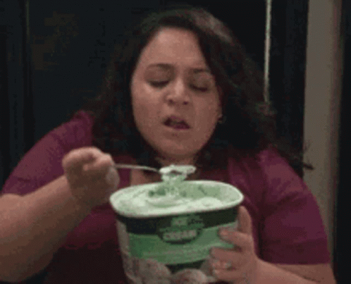 A Woman Is Eating Ice Cream With A Fork GIF