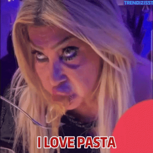 A Woman Is Eating Pasta With A Fork And The Words I Love Pasta Below Her GIF