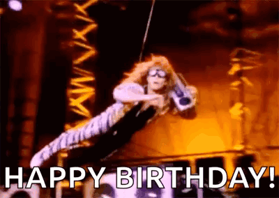 A Woman Is Flying Through The Air On A Rope While Holding A Guitar And Says `` Happy Birthday '' . GIF