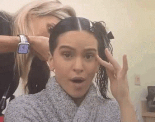A Woman Is Getting Her Hair Cut By A Hairdresser While Another Woman Looks On . GIF