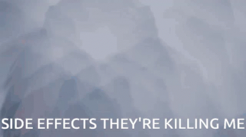 A Woman Is Hanging Upside Down With The Words Side Effects They 'Re Killing Me Behind Her GIF