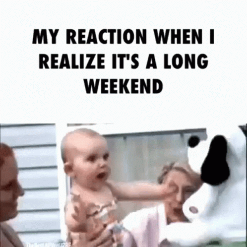 A Woman Is Holding A Baby In Her Arms While A Stuffed Animal Looks On . GIF