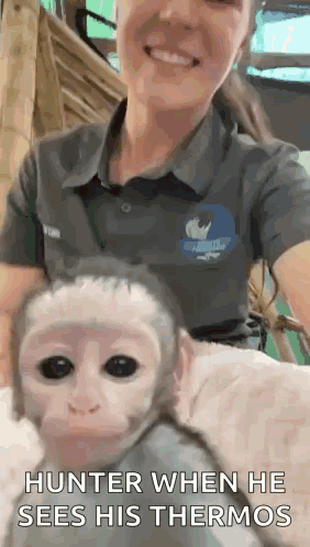 A Woman Is Holding A Baby Monkey With The Caption Hunter When He Sees His Thermos . GIF