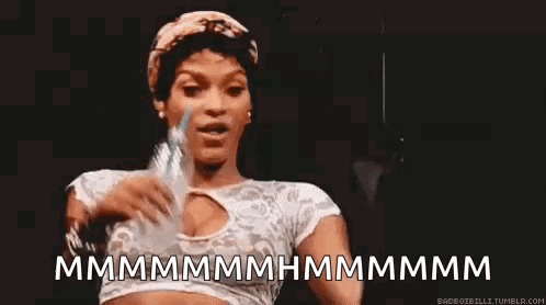 A Woman Is Holding A Bottle Of Water In Her Hand And Making A Face . GIF
