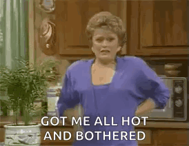 A Woman Is Holding A Bottle Of Water In Her Hand In A Kitchen . GIF