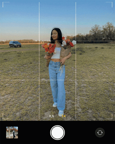 A Woman Is Holding A Bouquet Of Flowers In A Field With The Number 0.5 Visible GIF