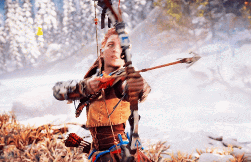 A Woman Is Holding A Bow And Arrow In A Snowy Forest GIF