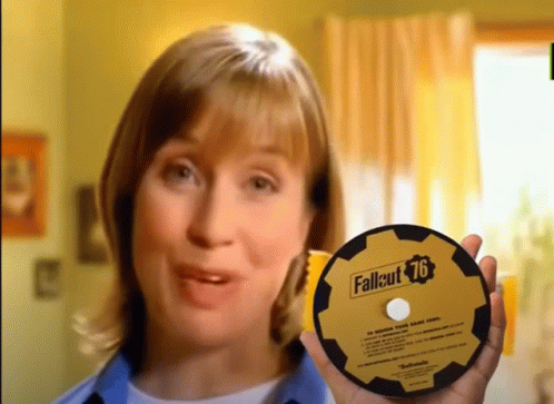 A Woman Is Holding A Cd That Says Fallout 76 GIF