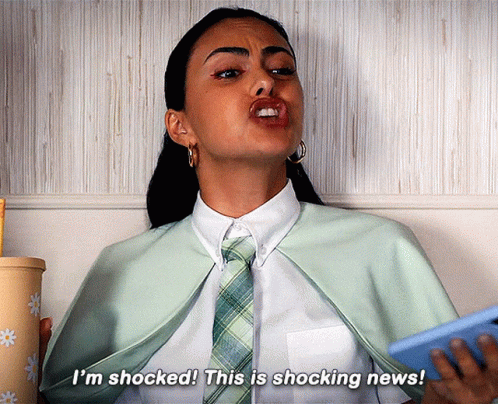 A Woman Is Holding A Cell Phone And Saying I 'M Shocked ! This Is Shocking News ! GIF