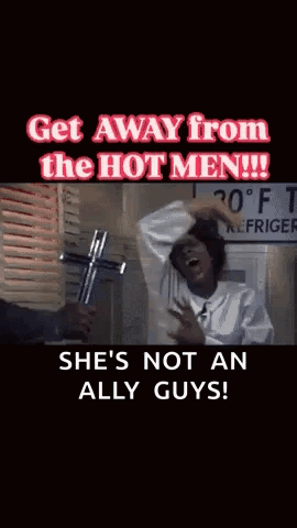 A Woman Is Holding A Cross In Front Of A Sign That Says Refrigerator GIF