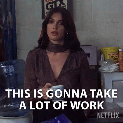 a woman is holding a cup of coffee and saying " this is gonna take a lot of work "