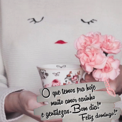 A Woman Is Holding A Cup Of Coffee With Pink Flowers In Her Hands GIF