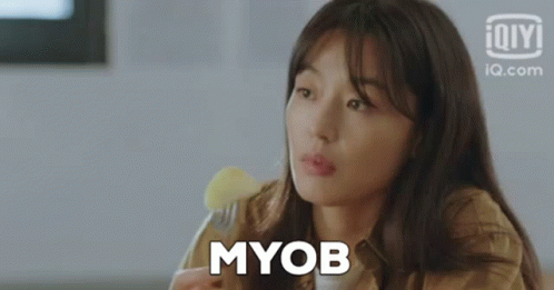 A Woman Is Holding A Fork And Eating A Piece Of Food . GIF