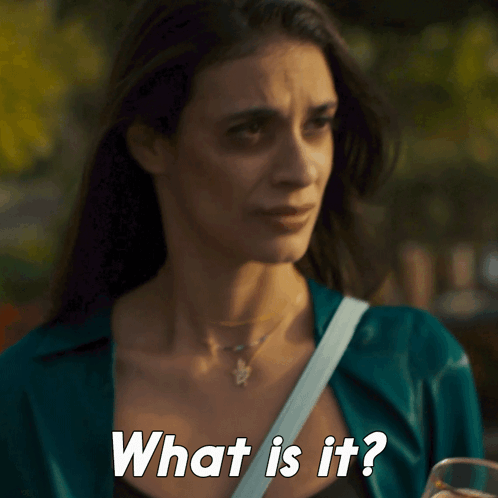 A Woman Is Holding A Glass Of Beer And Asking What Is It GIF